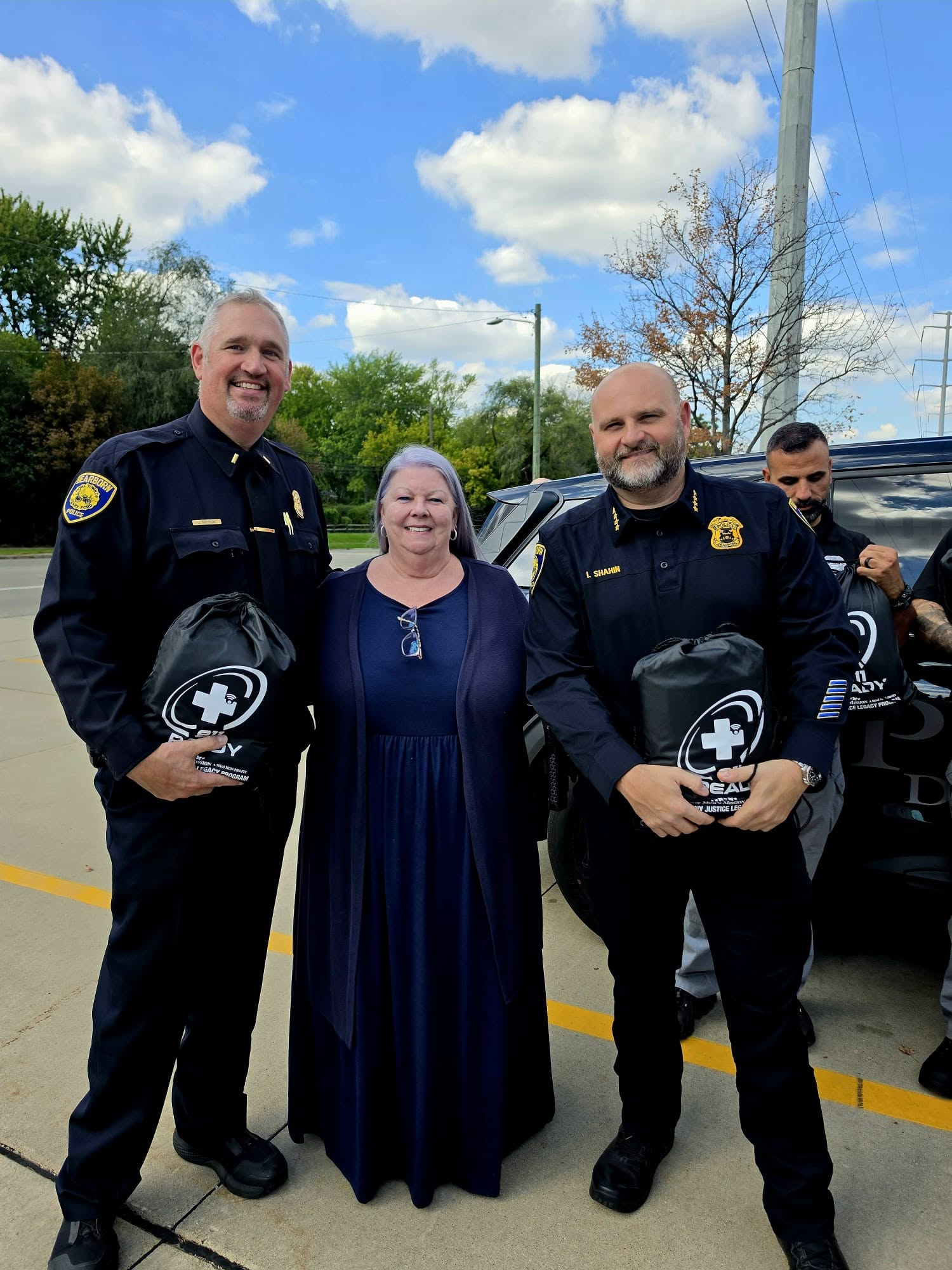 lisa and first responders holding 911ready bags
